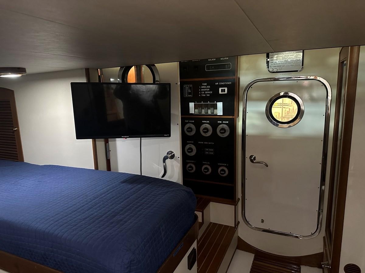 a room with a bed and a television aboard BANDOL Yacht for Sale