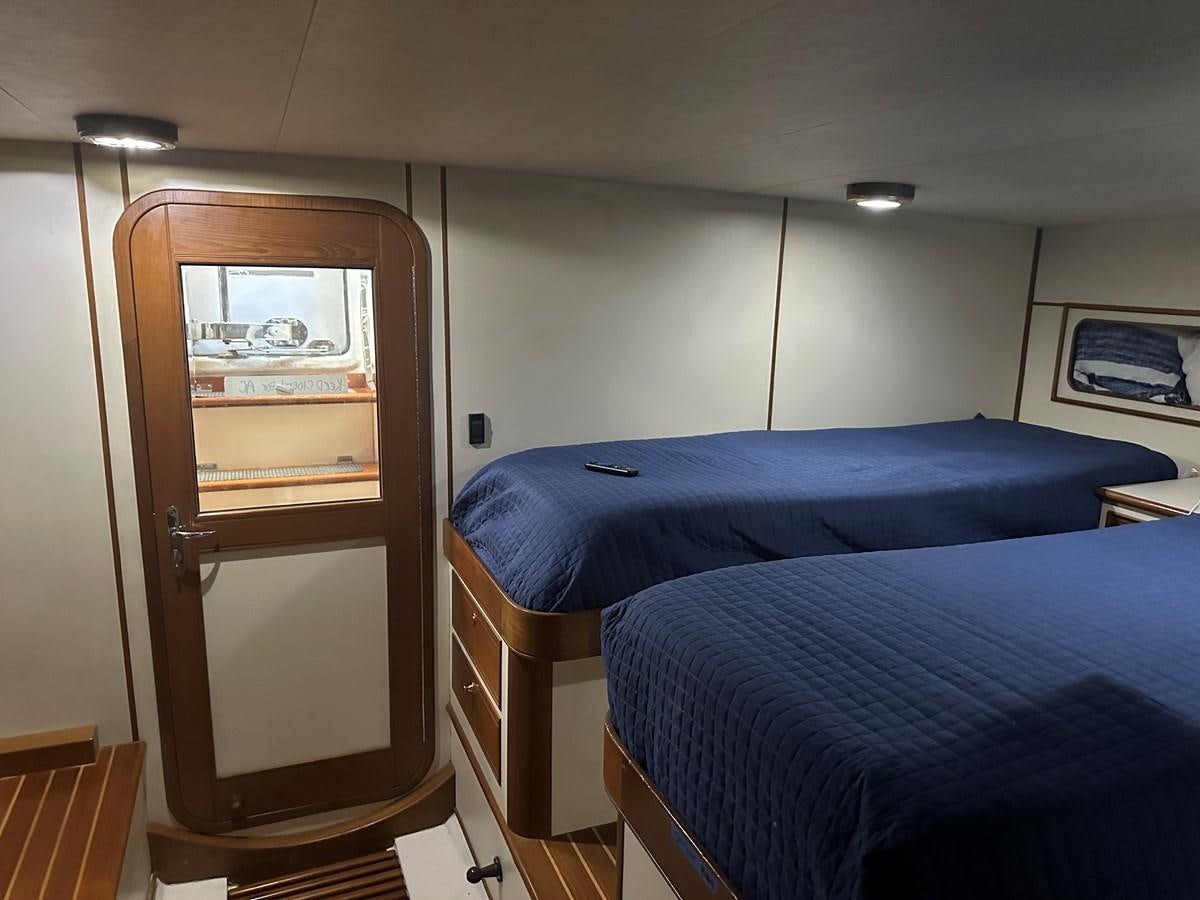 a room with a bed and a closet aboard BANDOL Yacht for Sale
