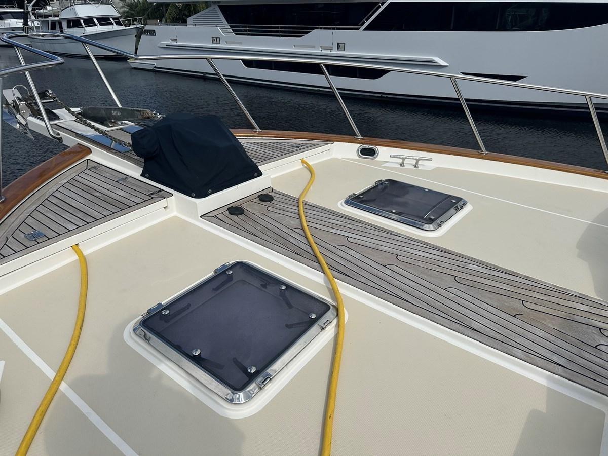 a black laptop on a white table aboard BANDOL Yacht for Sale