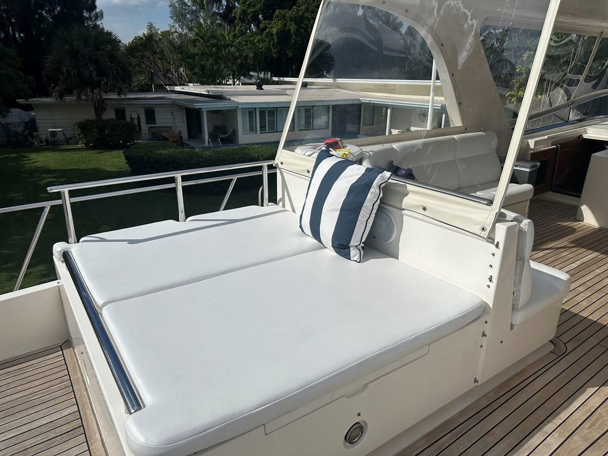 a white boat with a canopy aboard BANDOL Yacht for Sale