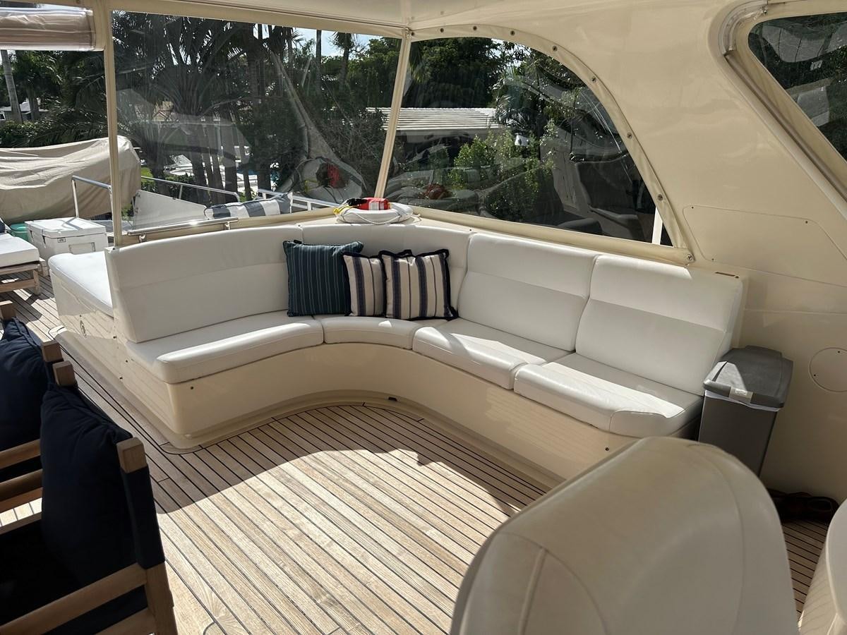 a white couch with a striped pillow aboard BANDOL Yacht for Sale