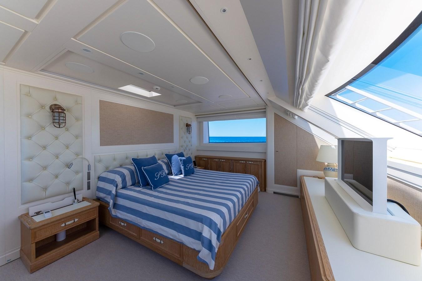 a bedroom with a bed and a tv aboard MY WAY Yacht for Sale