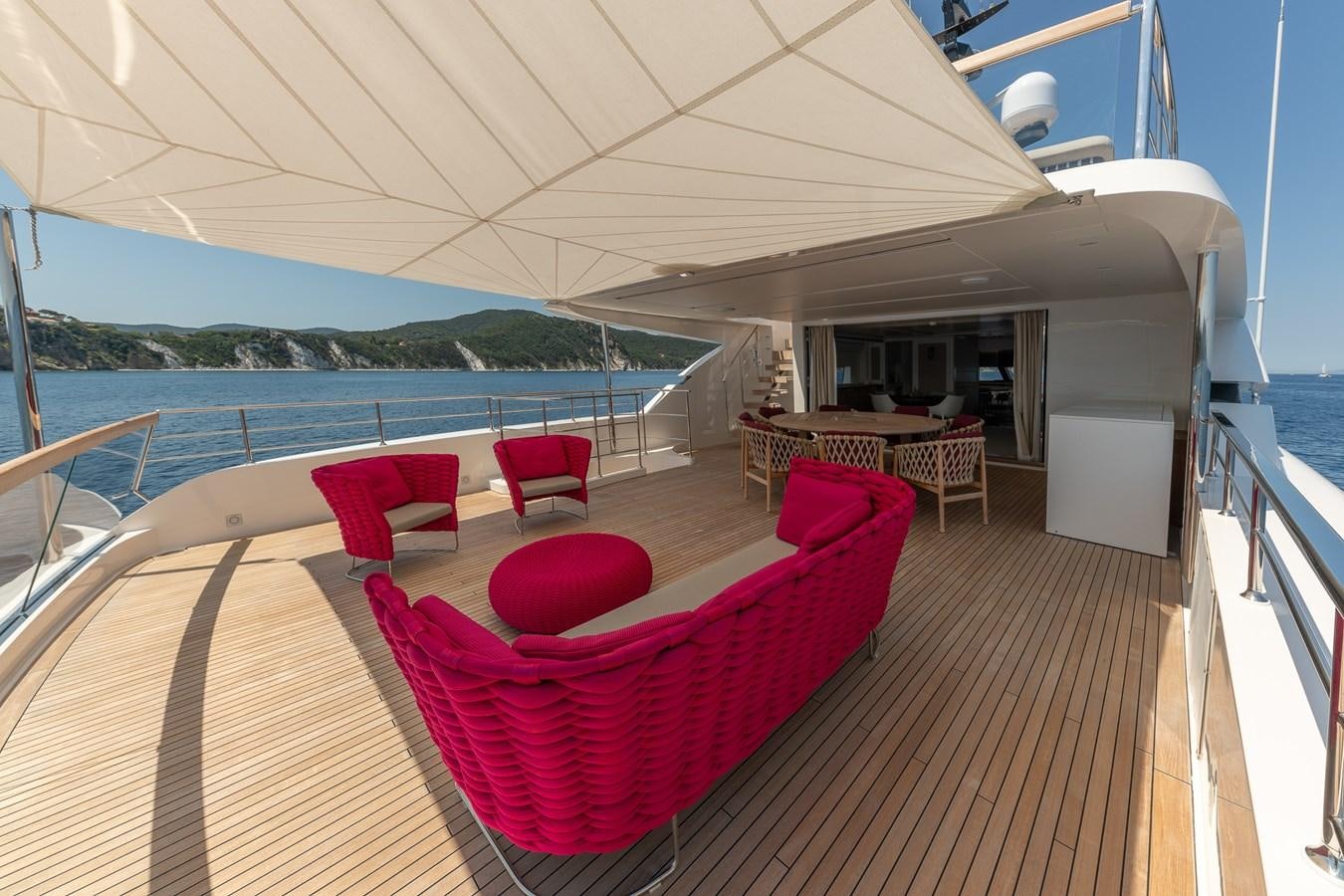 a deck with chairs and a table on it aboard MY WAY Yacht for Sale