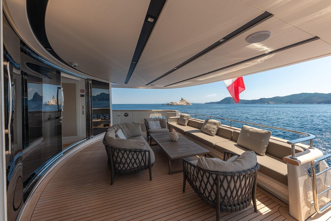 a deck with chairs and a view of the ocean aboard MY WAY Yacht for Sale