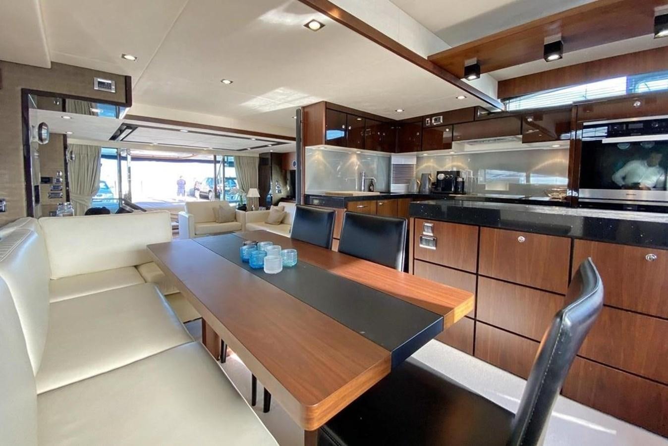a kitchen with a table and chairs aboard SQUADRON 80 Yacht for Sale