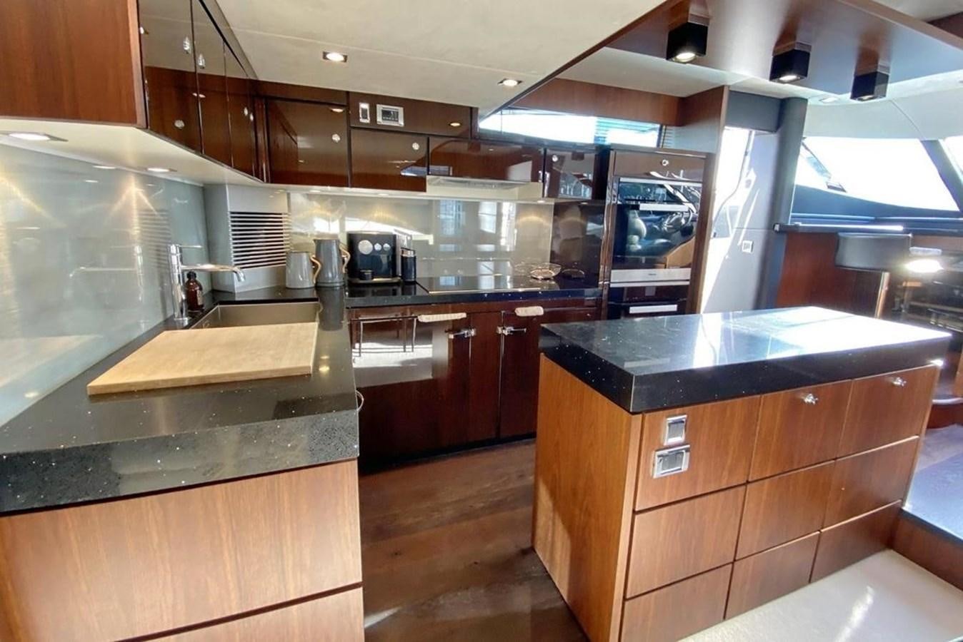 a kitchen with a large island aboard SQUADRON 80 Yacht for Sale