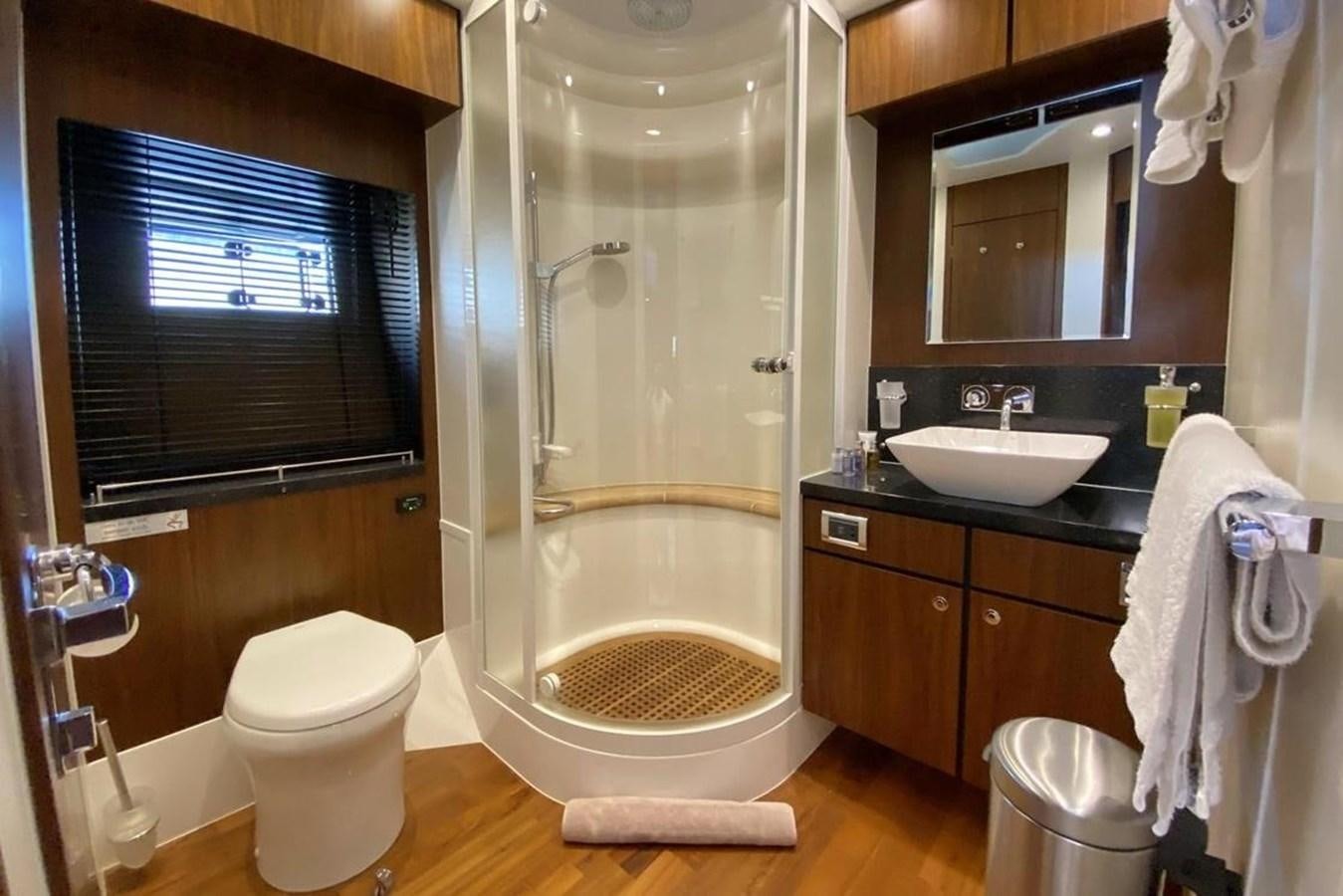 a bathroom with a toilet and a sink aboard SQUADRON 80 Yacht for Sale