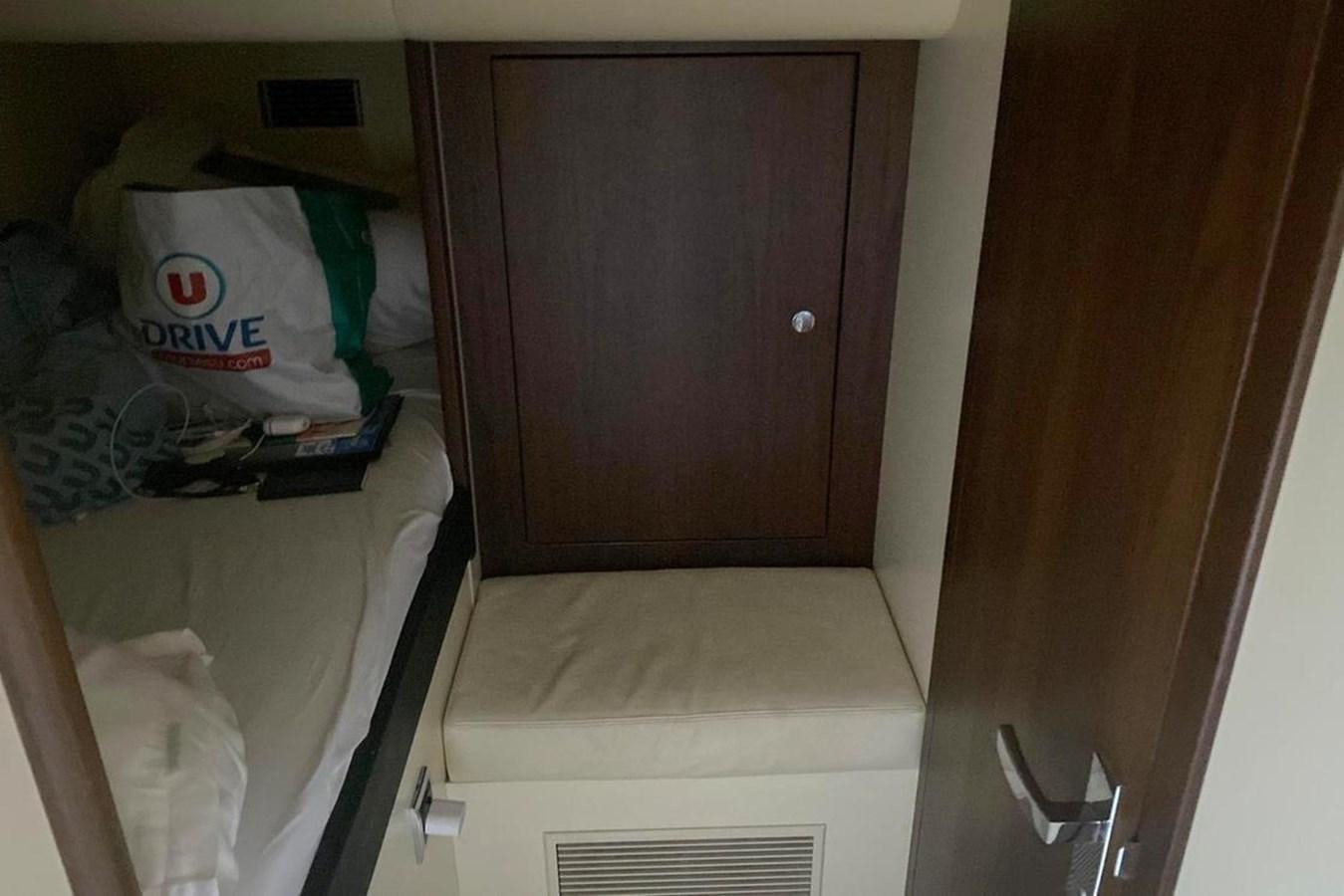 a closet with clothes and a toilet aboard SQUADRON 80 Yacht for Sale