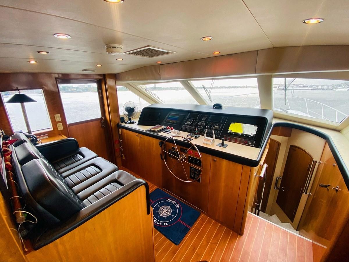 inside of a vehicle with a desk and chairs aboard DREAM ON Yacht for Sale