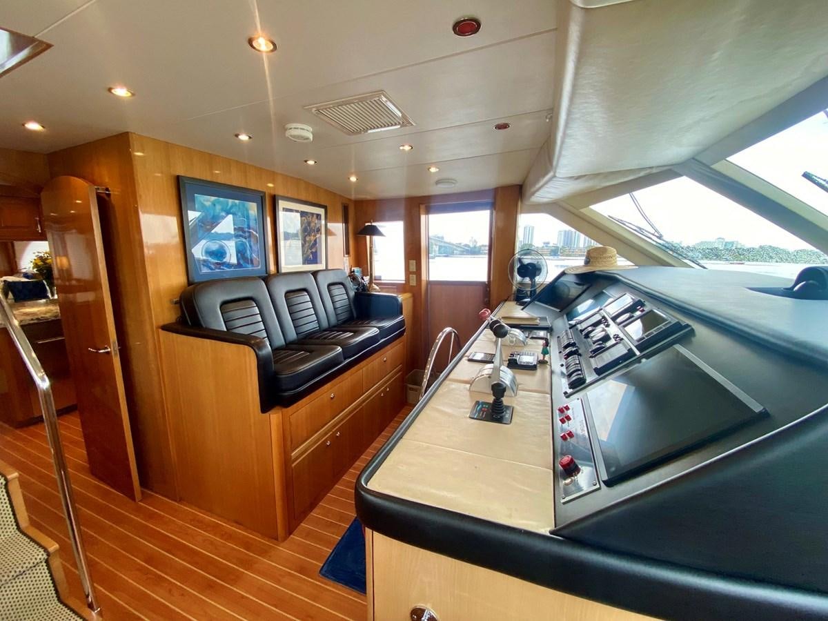 a room with a large window and a table with chairs and a large window aboard DREAM ON Yacht for Sale