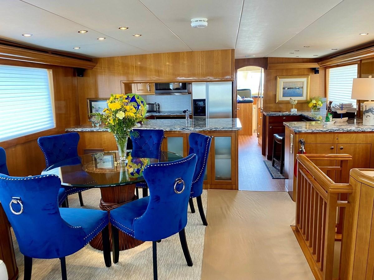 a kitchen with a table and chairs aboard DREAM ON Yacht for Sale