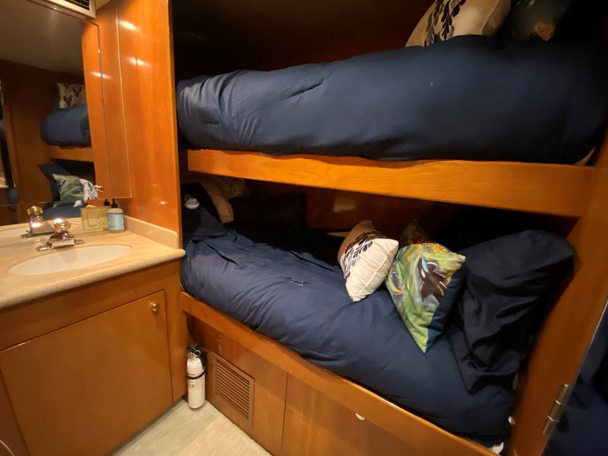 a bed with a blue blanket aboard DREAM ON Yacht for Sale