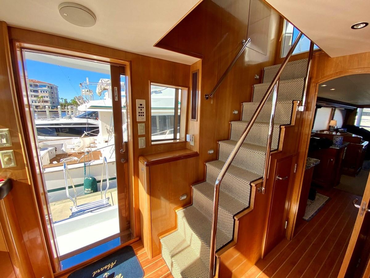 a wooden staircase leading to a glass door aboard DREAM ON Yacht for Sale