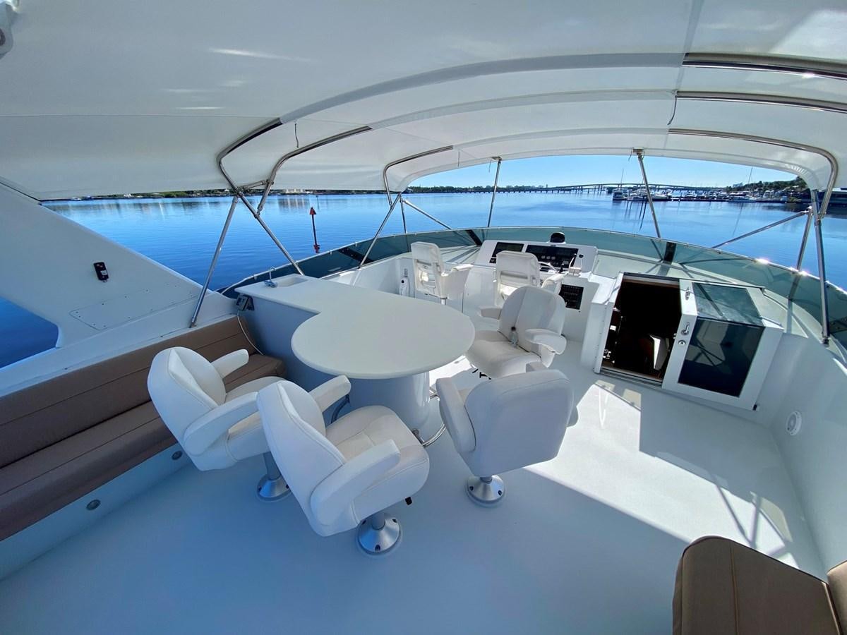 a large white boat with chairs aboard DREAM ON Yacht for Sale