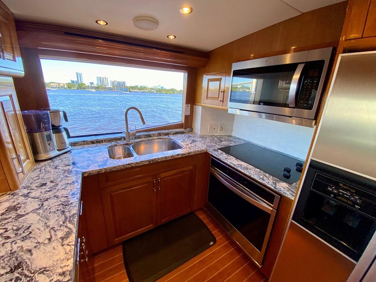 a kitchen with a microwave oven and a sink aboard DREAM ON Yacht for Sale