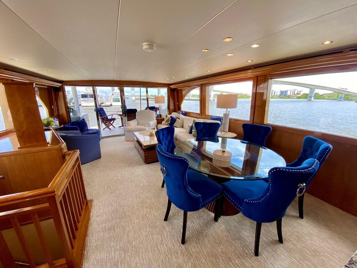 a room with a table chairs and a window aboard DREAM ON Yacht for Sale