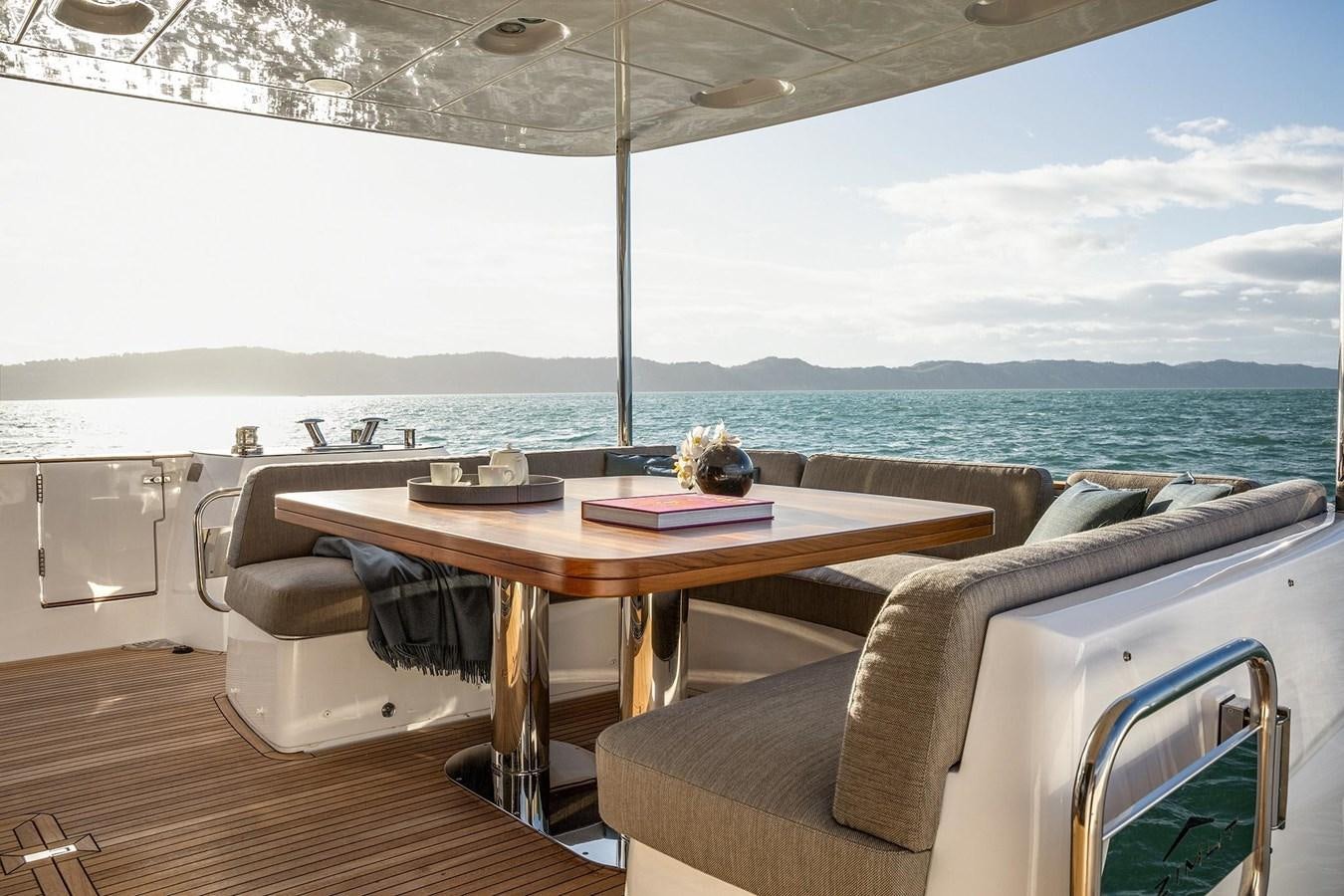 a table and chairs on a boat aboard AZIMUT MAGELLANO 66 Yacht for Sale