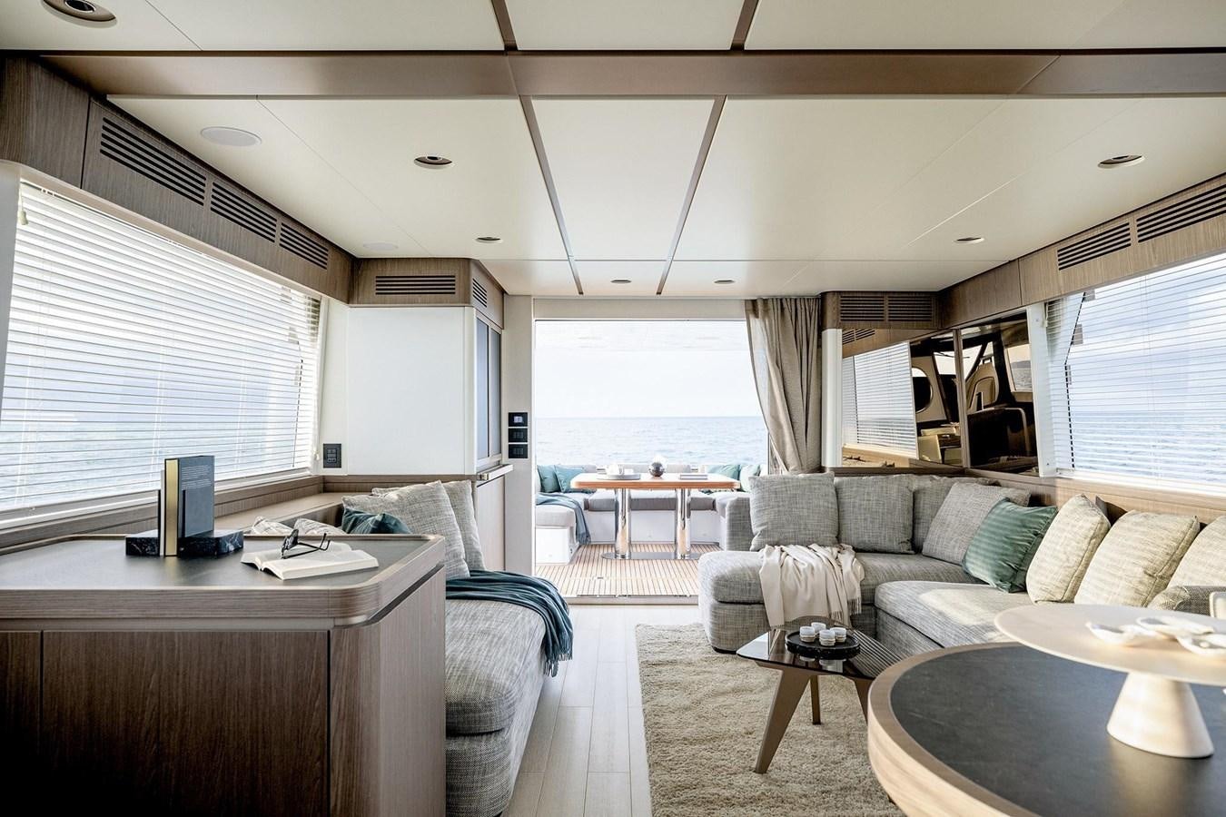 a living room with a couch and a table aboard AZIMUT MAGELLANO 66 Yacht for Sale