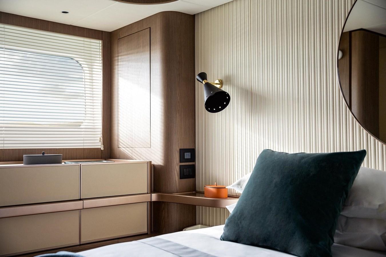 a bed with a lamp on it aboard AZIMUT MAGELLANO 66 Yacht for Sale