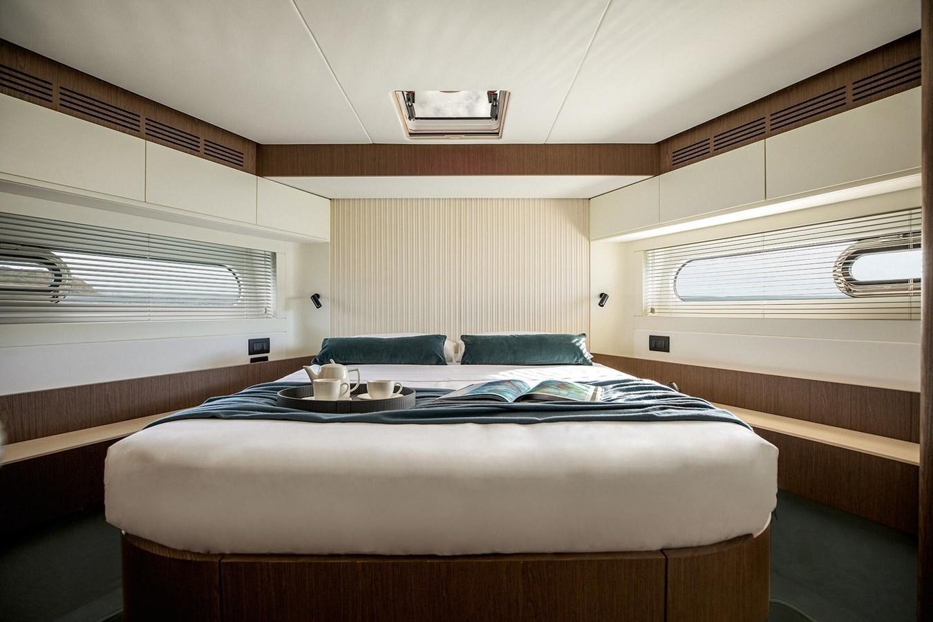 a small bedroom with a bed aboard AZIMUT MAGELLANO 66 Yacht for Sale
