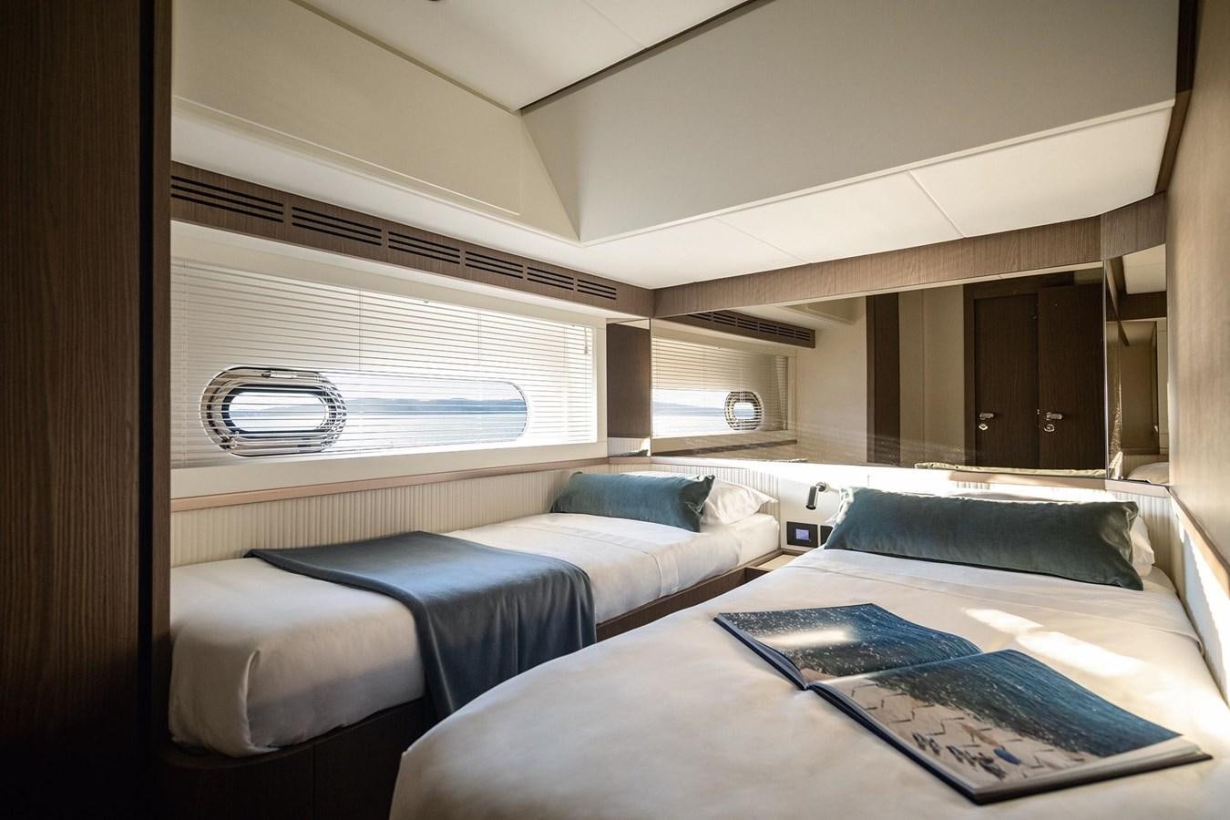 a room with a bed and a window aboard AZIMUT MAGELLANO 66 Yacht for Sale