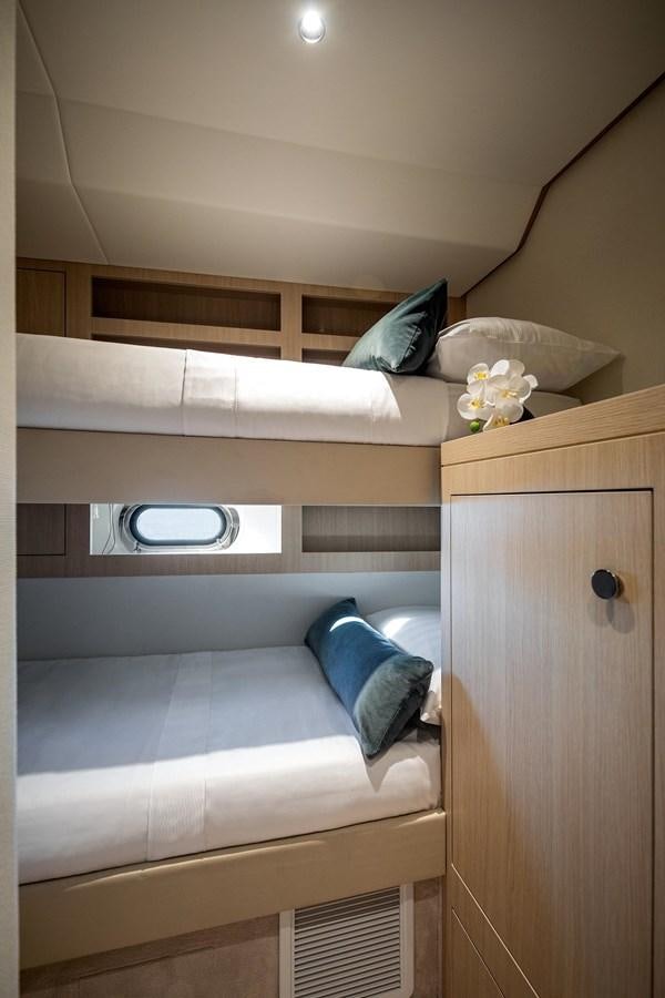 a bed with a white bed and a white pillow aboard AZIMUT MAGELLANO 66 Yacht for Sale