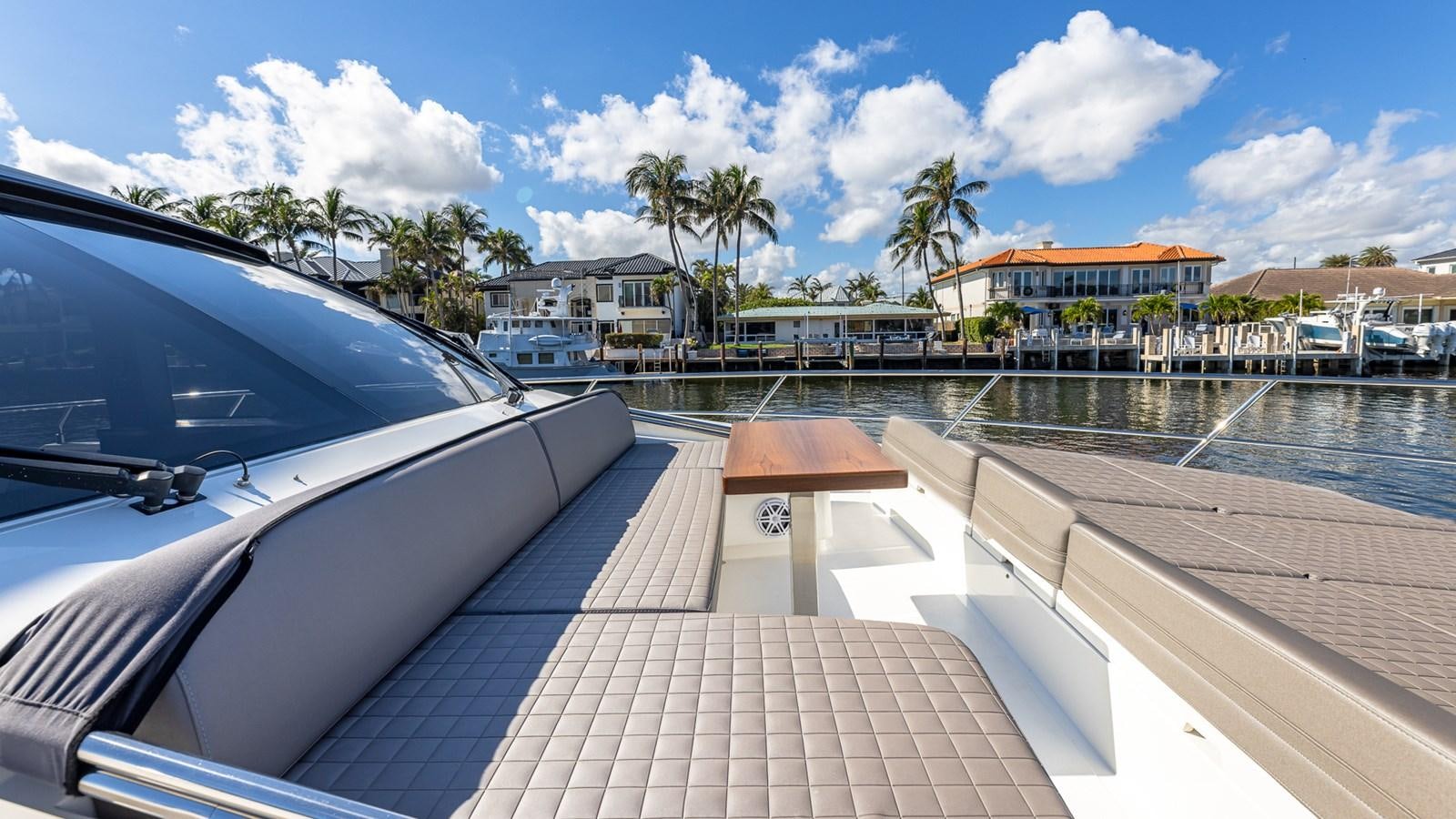 a deck with a pool and trees aboard ISLA BONITA Yacht for Sale