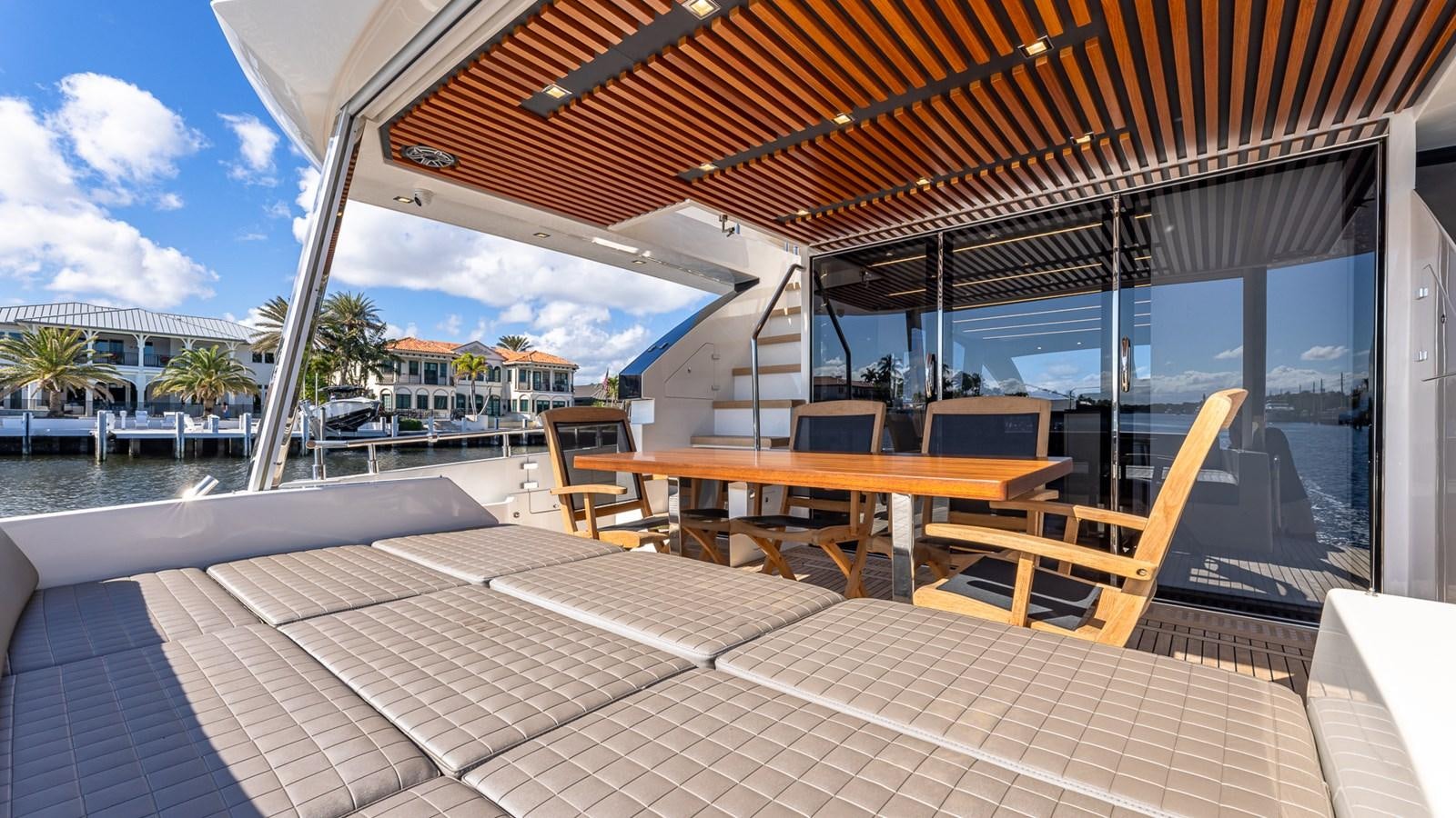 a deck with a table and chairs on it aboard ISLA BONITA Yacht for Sale