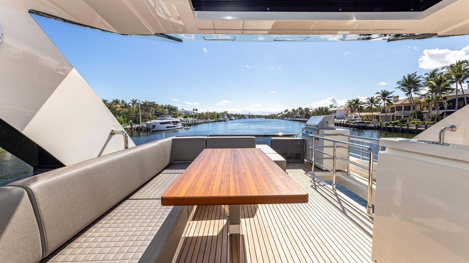 a deck with a view of a beach and water aboard ISLA BONITA Yacht for Sale