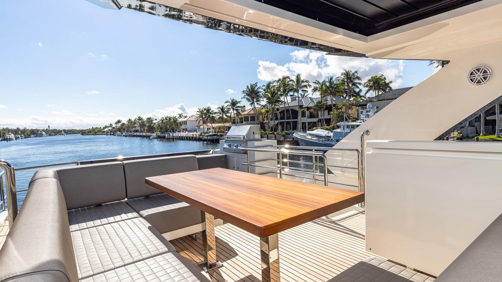 a table on a deck overlooking a body of water aboard ISLA BONITA Yacht for Sale