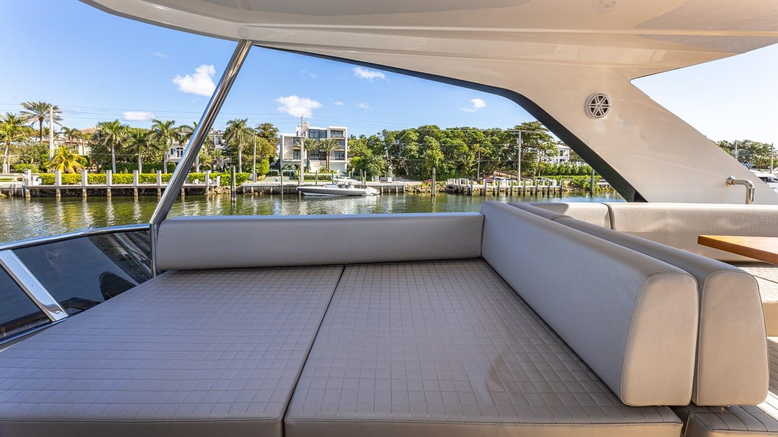 a deck with a view of a beach and trees aboard ISLA BONITA Yacht for Sale