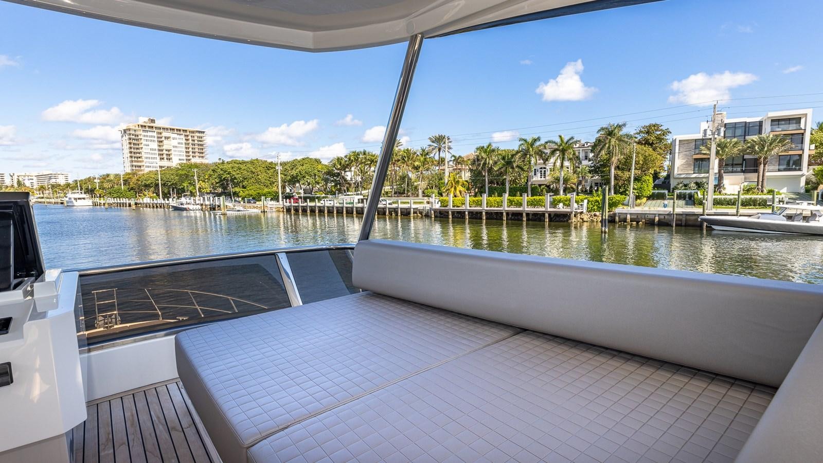 a deck with a pool and trees aboard ISLA BONITA Yacht for Sale