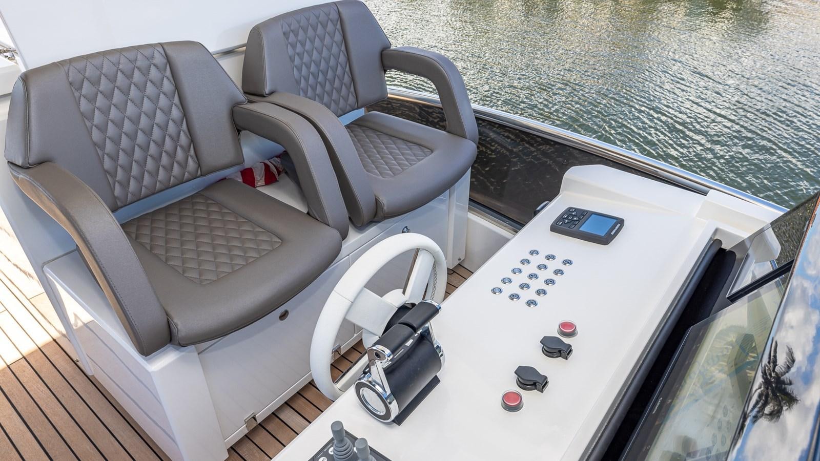 a car with a remote control and a game controller on the dashboard aboard ISLA BONITA Yacht for Sale