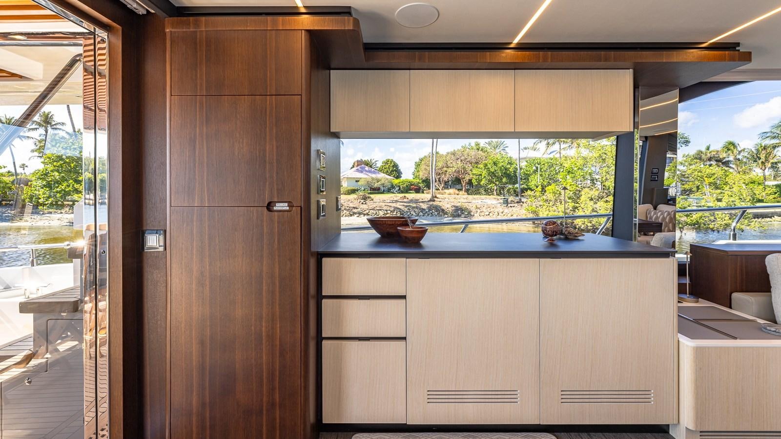 a room with a wood door and a wood cabinet with a window aboard ISLA BONITA Yacht for Sale