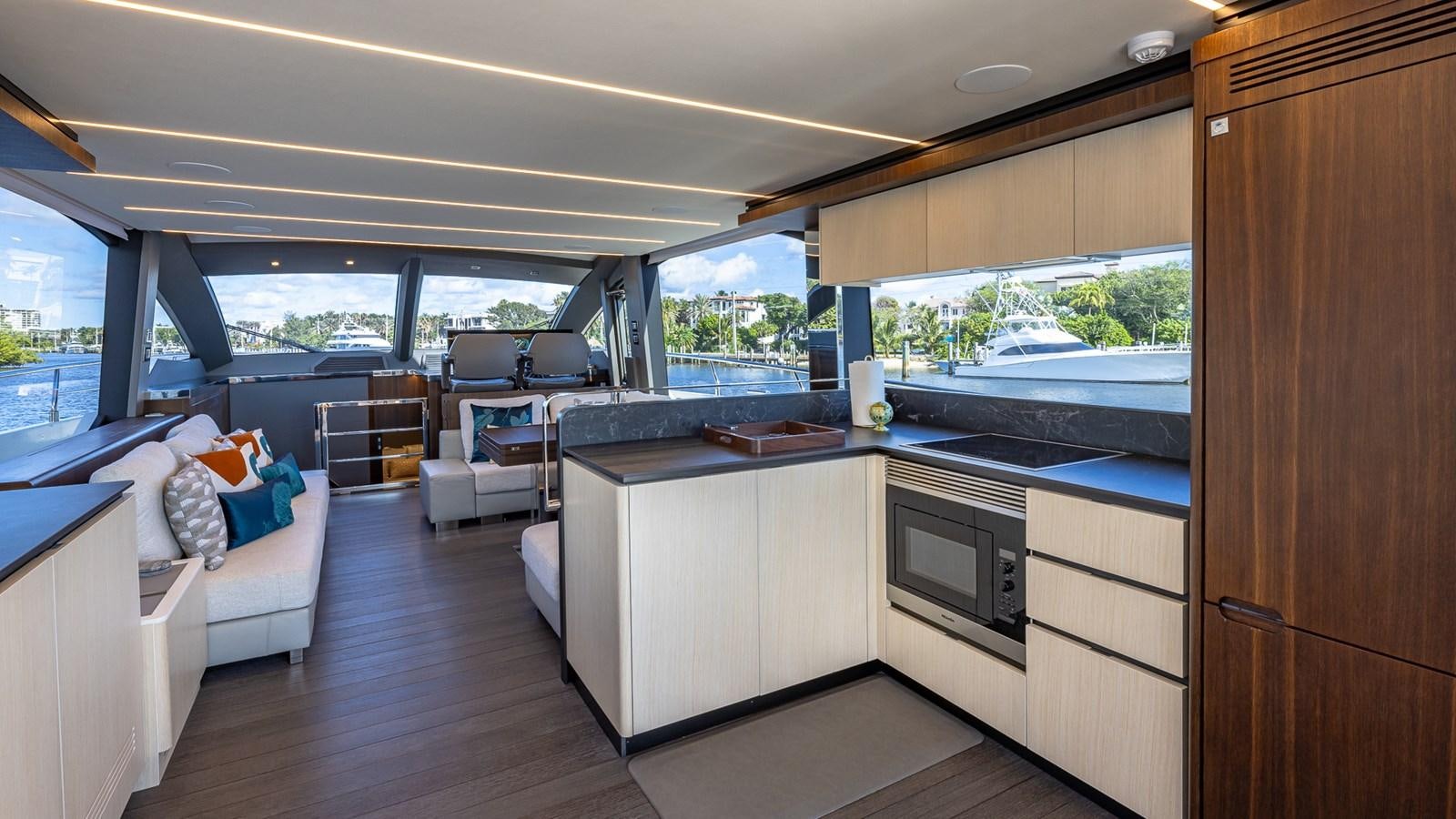 a room with a large window and a couch and a table aboard ISLA BONITA Yacht for Sale