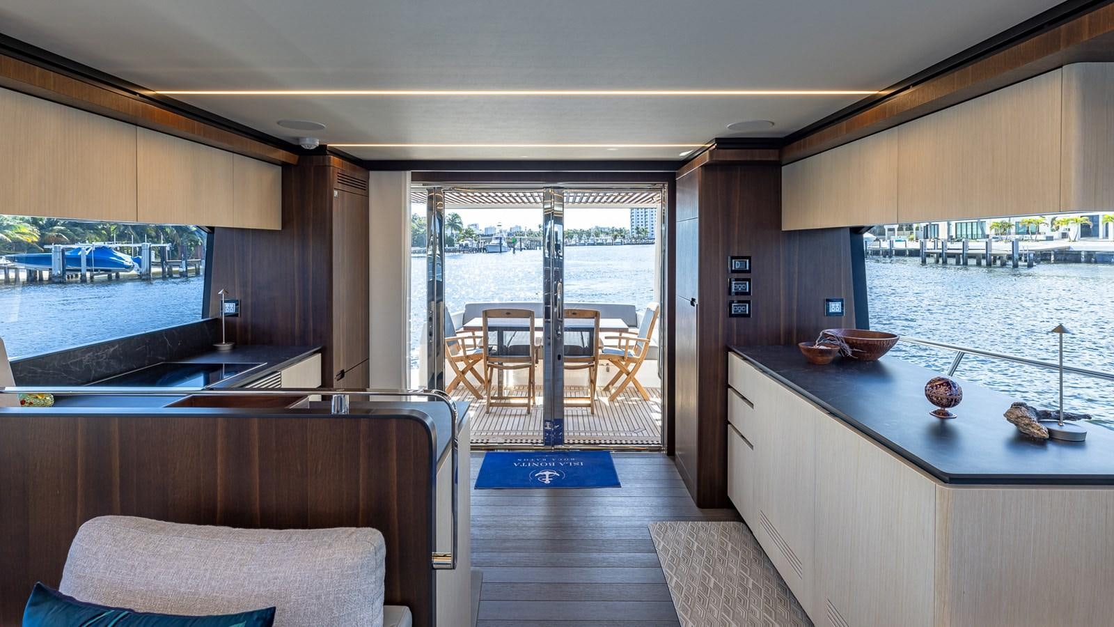 a room with a table chairs and a view of the water aboard ISLA BONITA Yacht for Sale