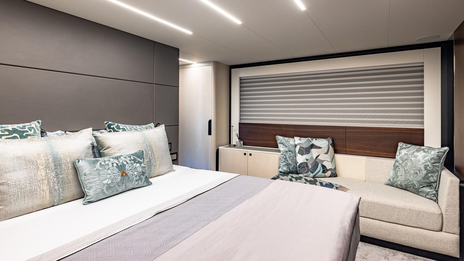 a bed with pillows and a couch aboard ISLA BONITA Yacht for Sale