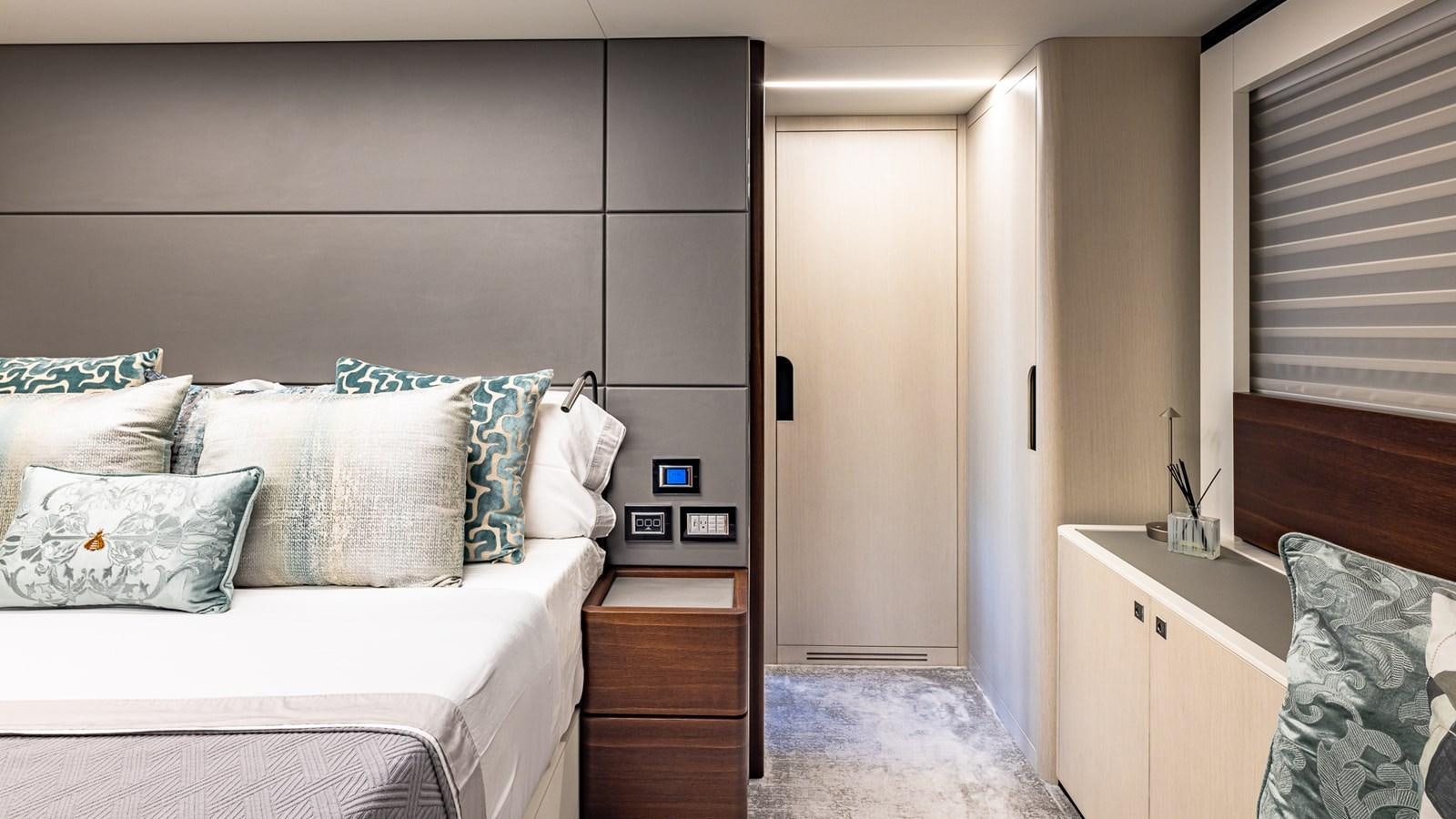 a bedroom with a bed and a desk aboard ISLA BONITA Yacht for Sale