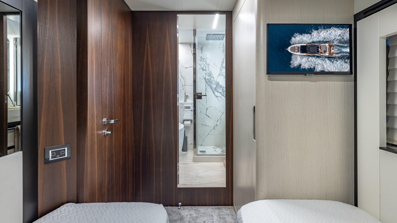 a room with a wood door and a bed and a picture on the wall aboard ISLA BONITA Yacht for Sale