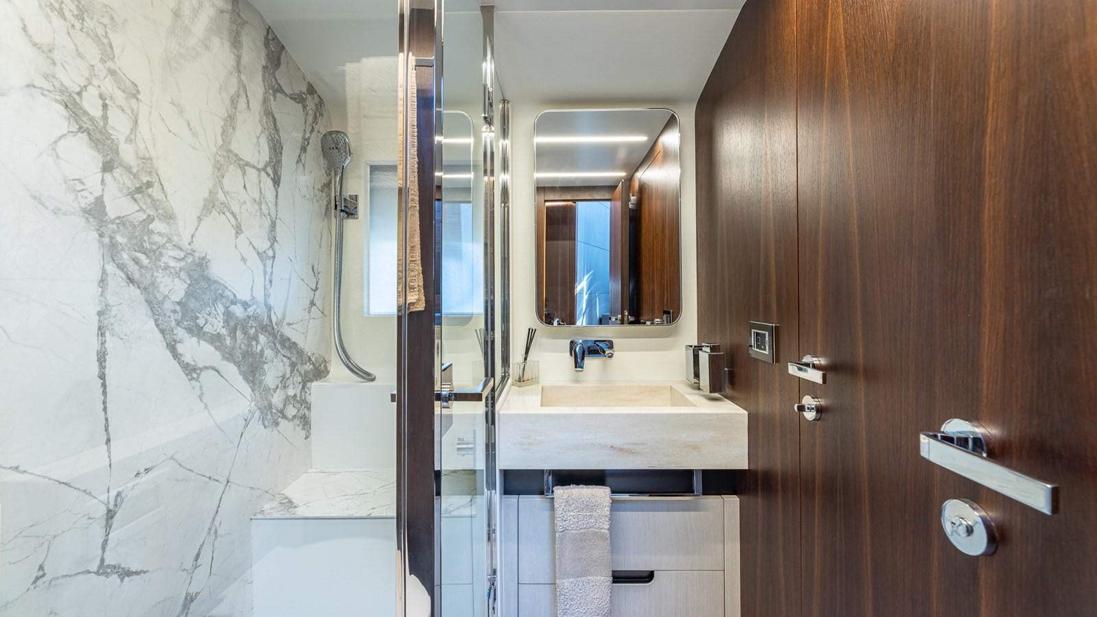 a bathroom with a sink and a mirror aboard ISLA BONITA Yacht for Sale