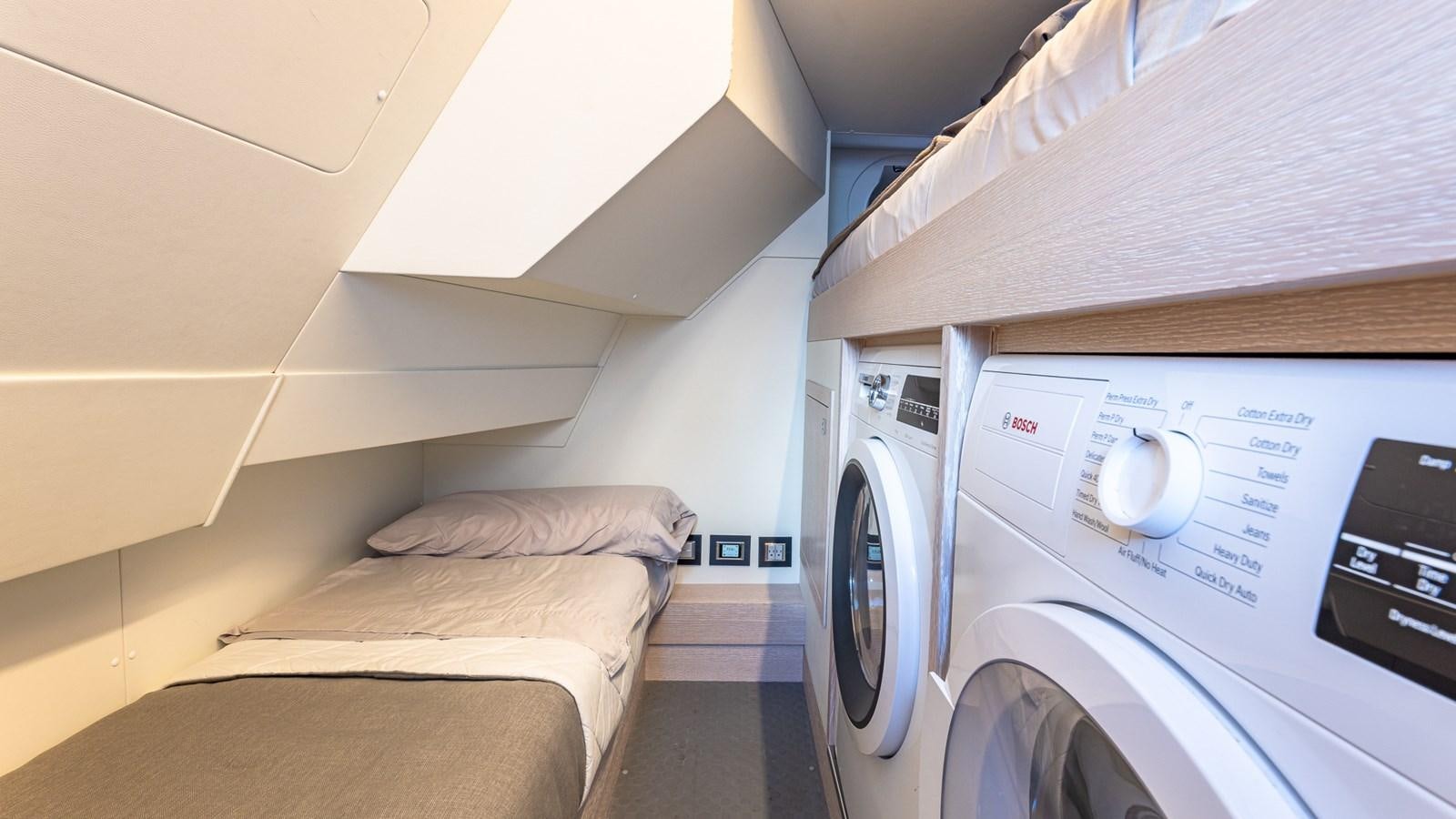 a room with a bed and a washing machine aboard ISLA BONITA Yacht for Sale