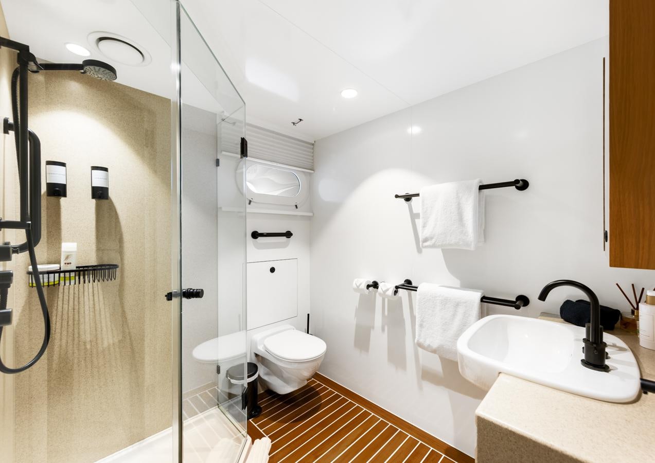 a bathroom with a shower and toilet aboard EVOLUTION 1 Yacht for Sale