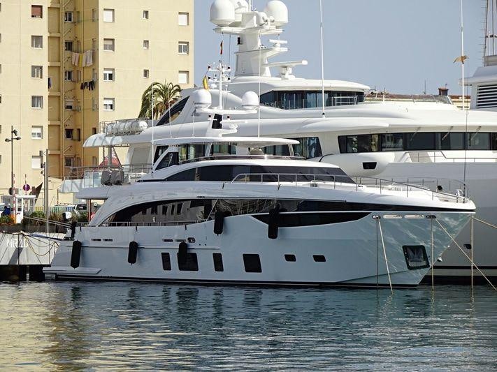 a large white yacht in a harbor aboard MINOR FAMILY AFFAIR Yacht for Charter