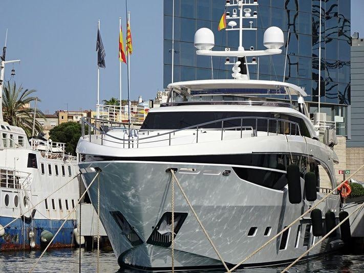 a large white boat in a harbor aboard MINOR FAMILY AFFAIR Yacht for Charter