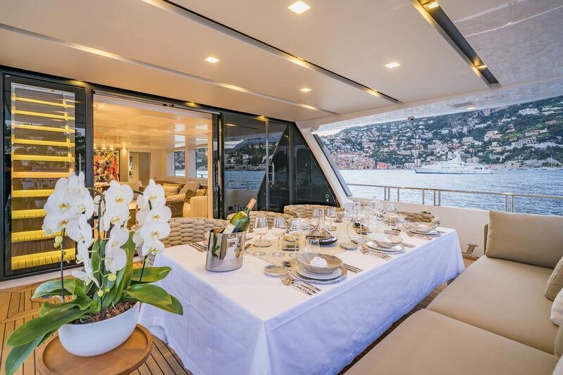 a table with plates and flowers aboard SALT Yacht for Charter