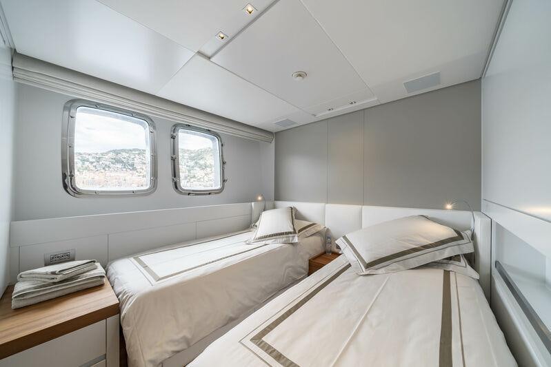 a room with two beds aboard SALT Yacht for Charter