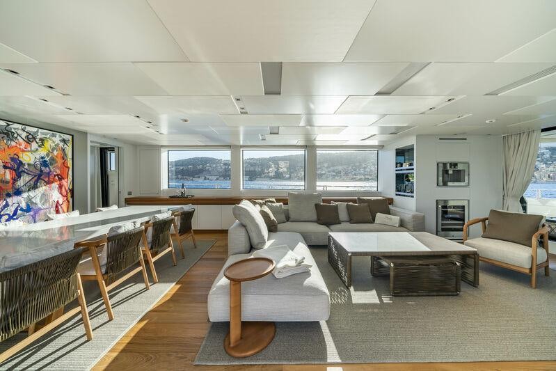 a living room with a large screen aboard SALT Yacht for Charter
