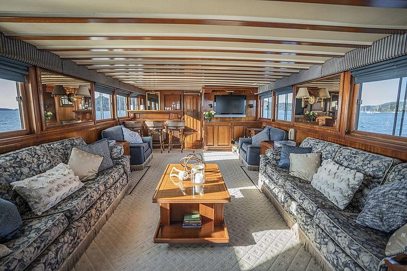 a living room with a couch and a table aboard SEA BREEZE III Yacht for Charter