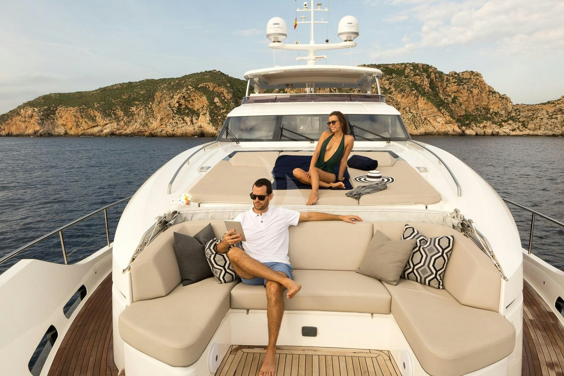 a man and woman sitting on a boat with a guitar aboard KOHUBA Yacht for Charter