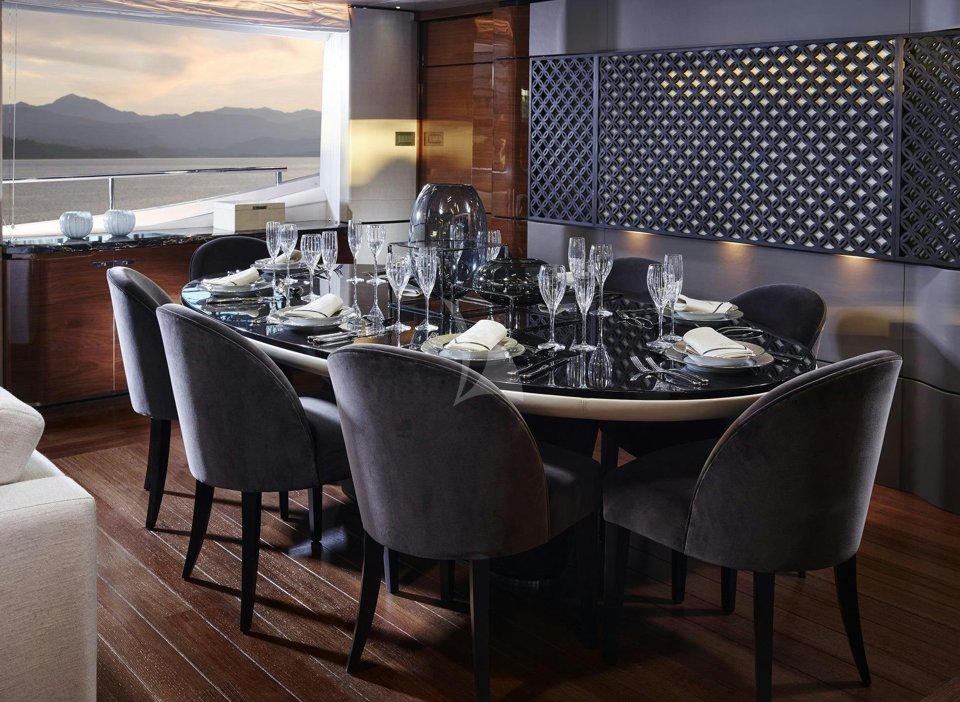 a table with chairs and a window aboard KOHUBA Yacht for Charter